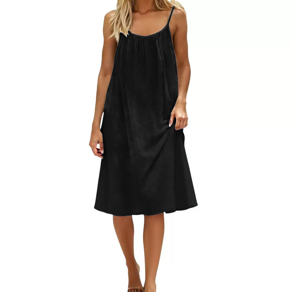 Black slip dress worn by a model on a white background