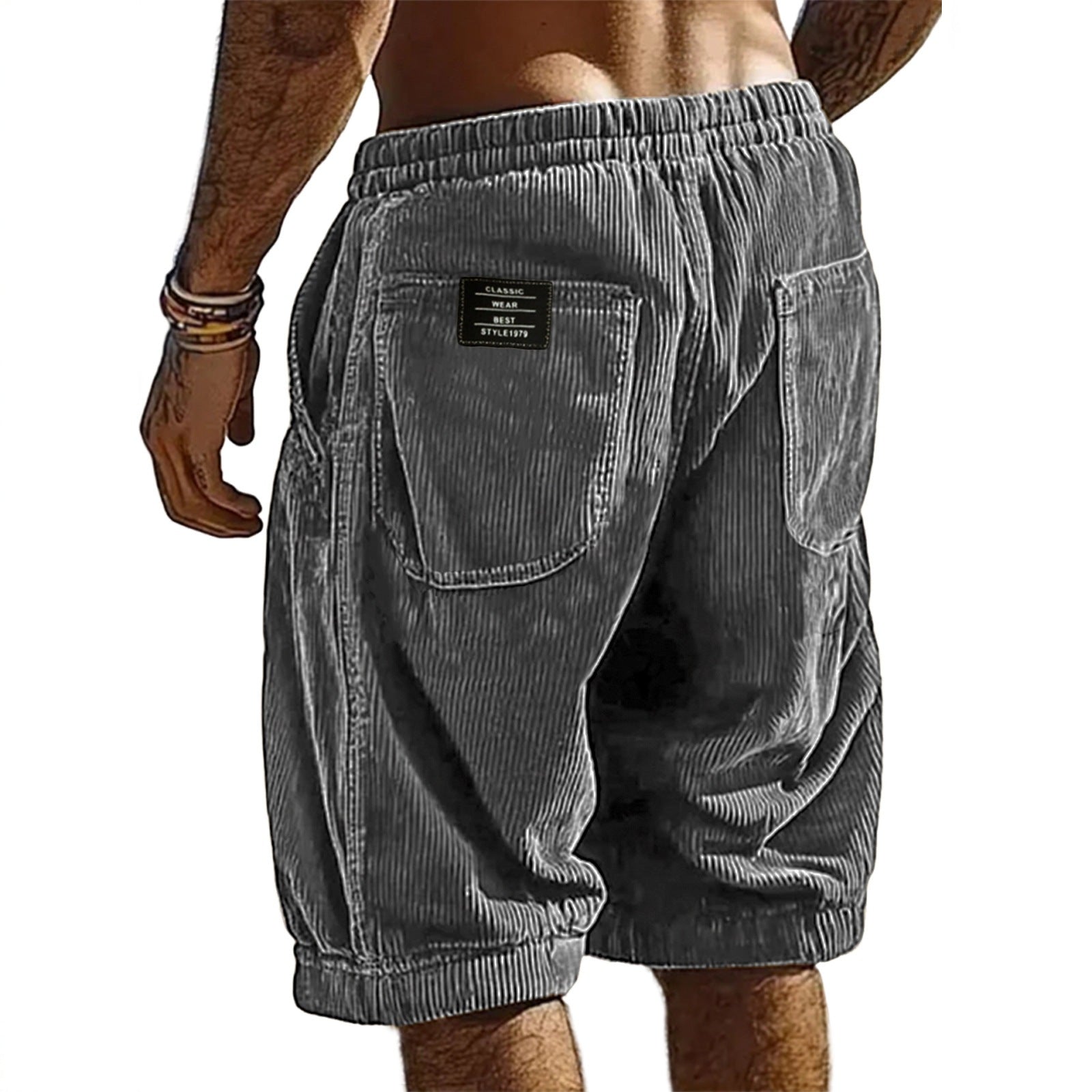 Gray corduroy shorts worn by a person on a white background