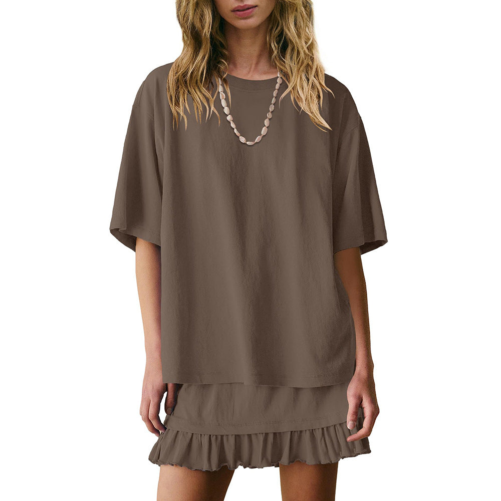 Brown dress with ruffled hem worn by a model on a white background