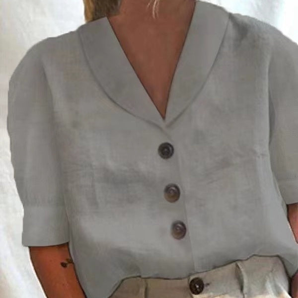 Gray blouse with buttons on a plain background