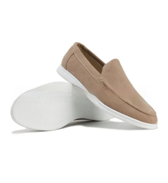 Tan slip-on shoe with white sole on a white background