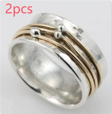 Silver ring with gold accents on a white background