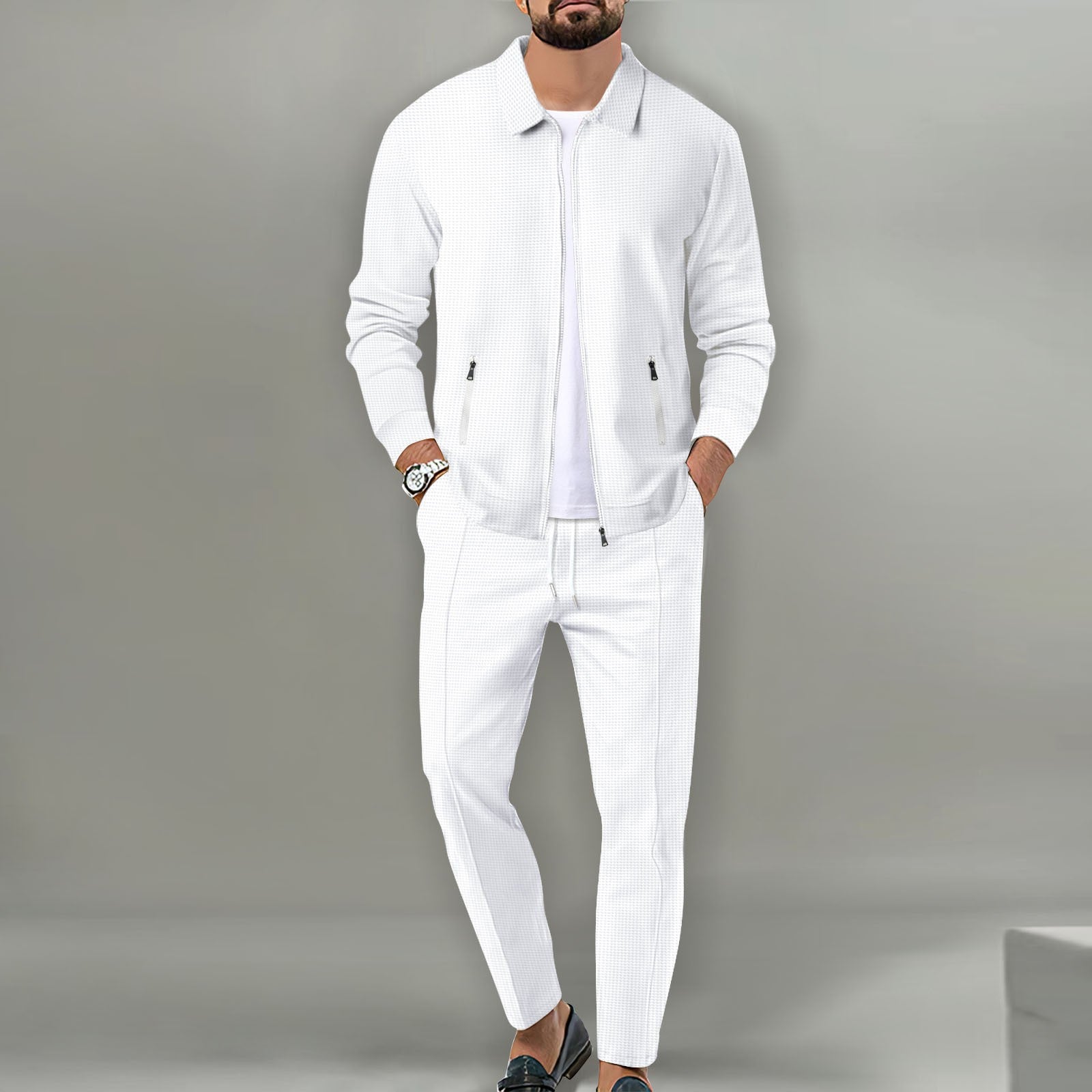 Man wearing a white outfit against a gray background