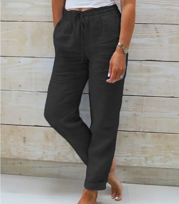 Person wearing black pants with a white background