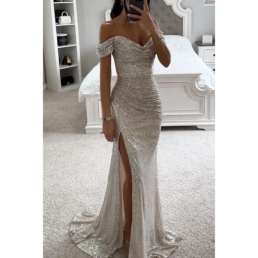 Person wearing a sparkly off-shoulder evening gown in a bedroom setting.