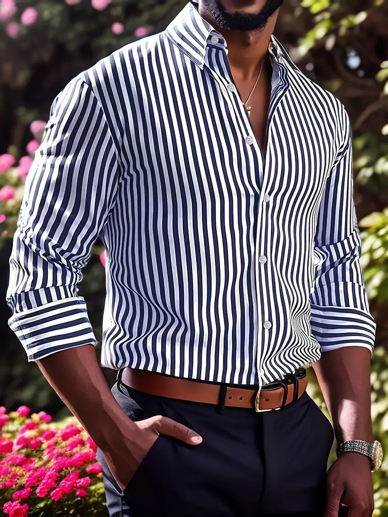 Man wearing a black and white striped shirt with a blurred floral background
