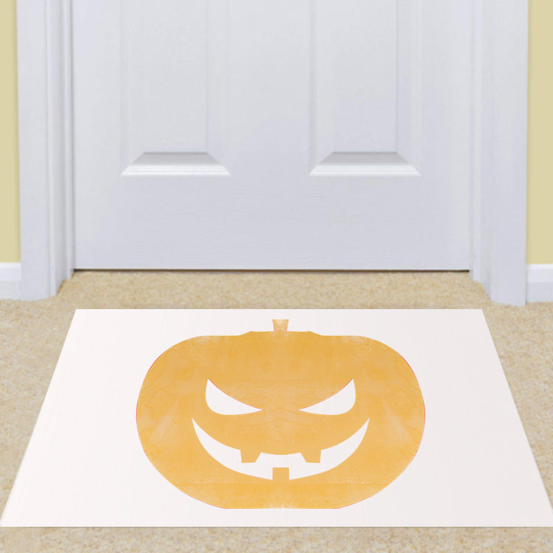 Halloween-themed doormat with pumpkin design on a beige floor.