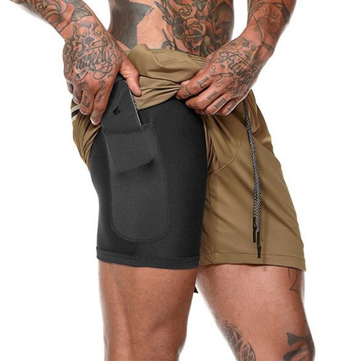 Person wearing a black and beige athletic shorts with a pocket on a white background