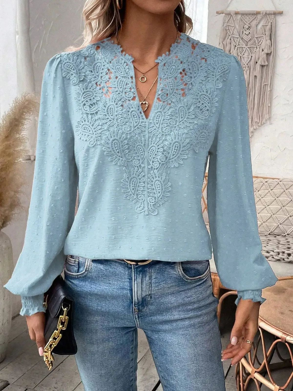 Light blue lace top worn by a person indoors
