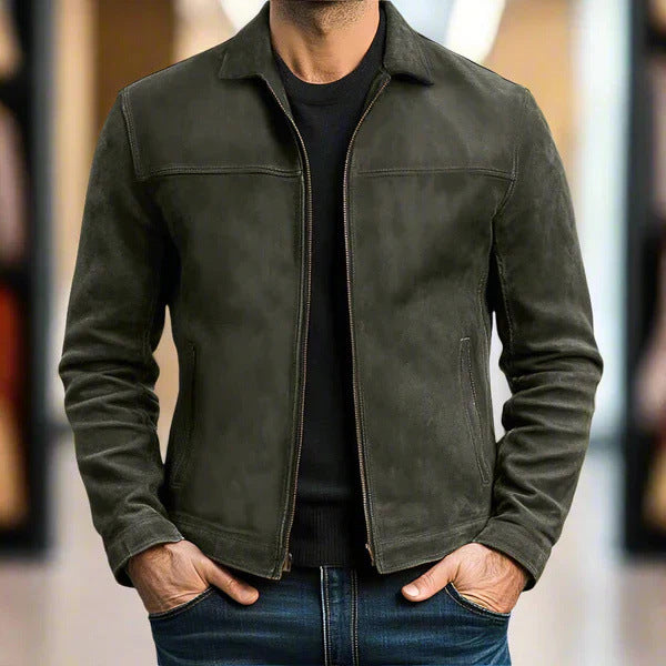 Person wearing a dark green jacket with a blurred background