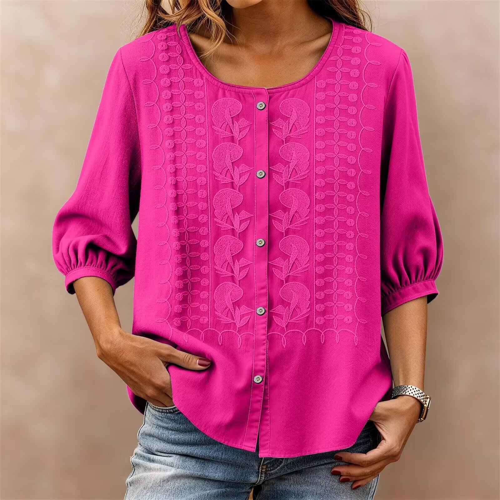 Pink blouse with intricate patterns on a beige background