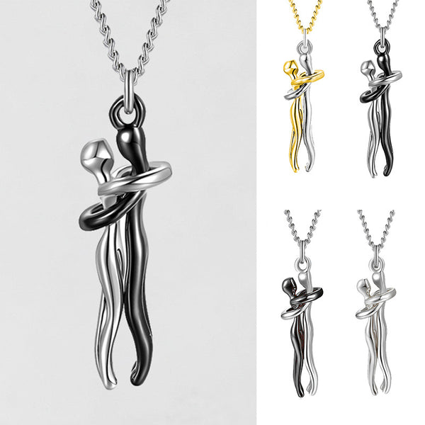 A silver-toned pendant necklace featuring two abstract human figures embracing, shown on a chain against a light gray background. Smaller inset views on the right show the pendant in black and silver, and black and gold color combinations.