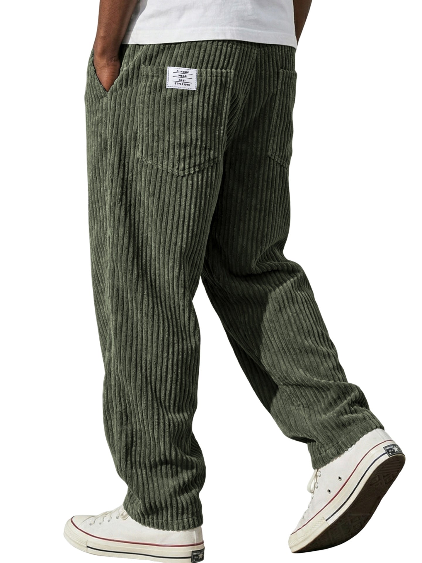 Green striped pants worn by a person on a white background