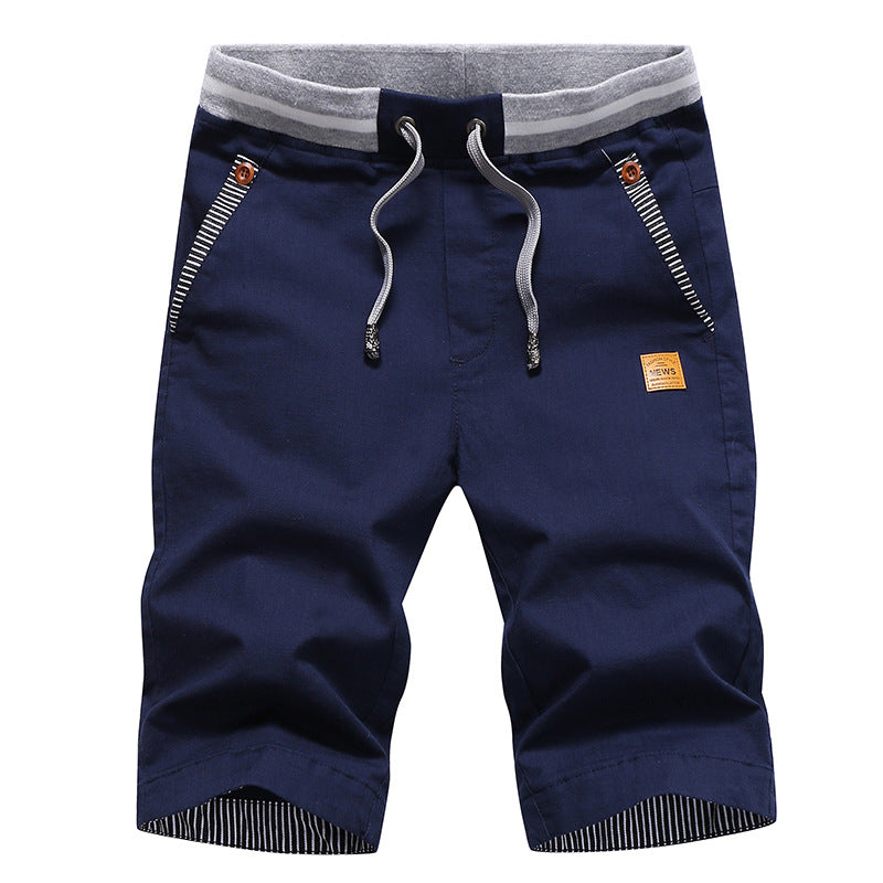 Navy blue shorts with drawstring and gray waistband on a white background