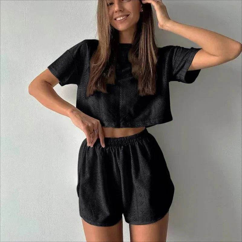 Woman wearing black two-piece lounge set with crop top and high-waisted shorts, ZA-Zola fashion