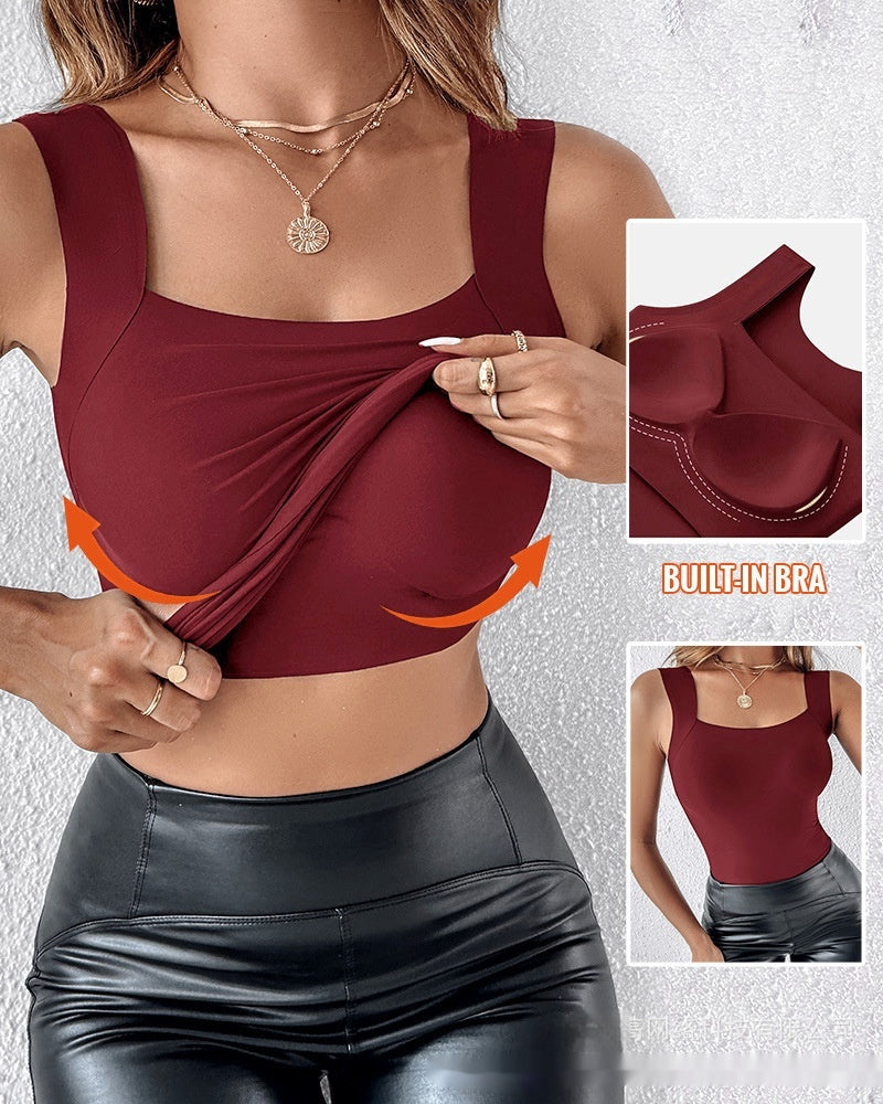 Maroon sports bra with built-in bra feature and black leggings on a textured gray background.