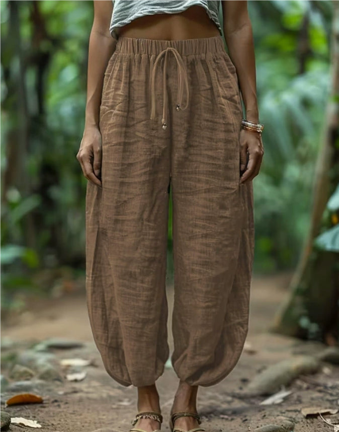 Person wearing brown linen pants in a natural setting