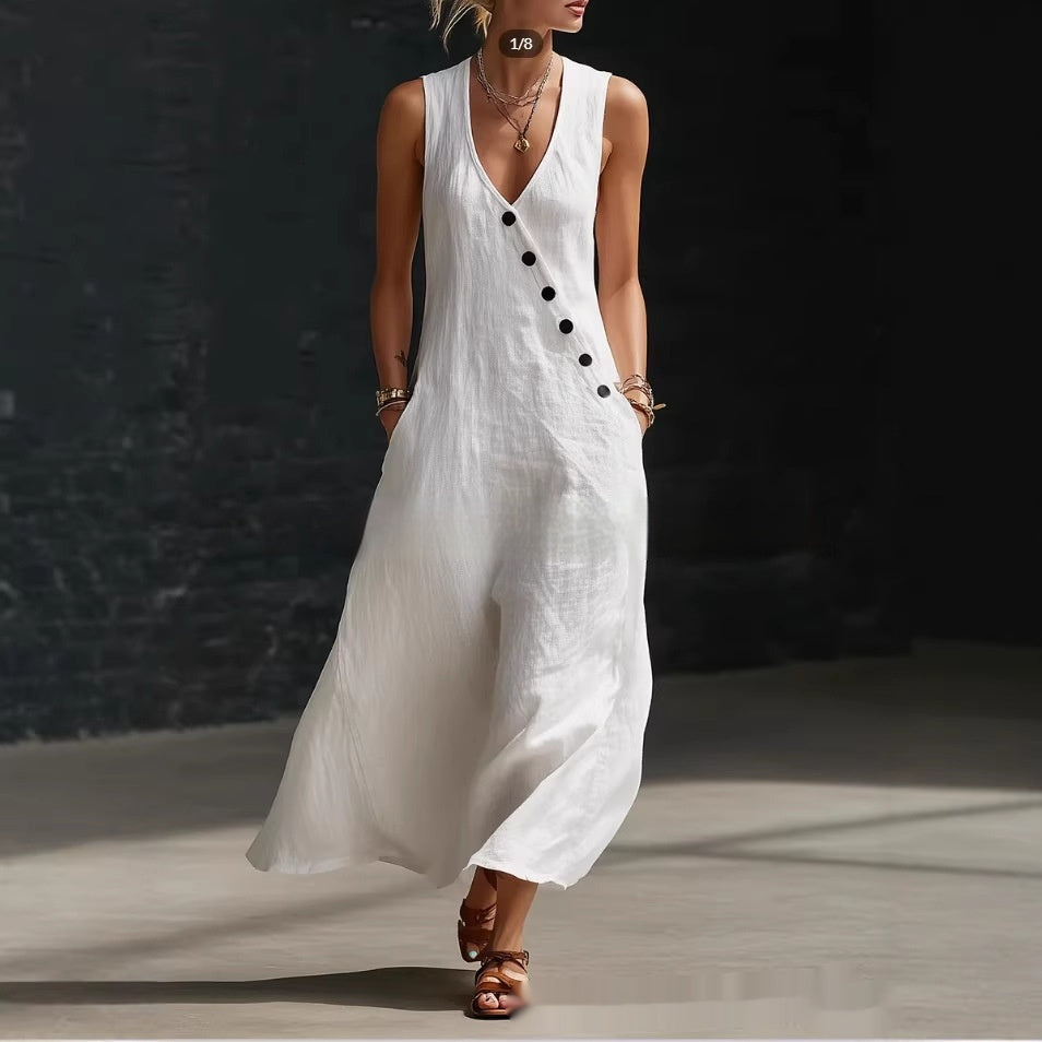 Woman wearing a white sleeveless dress with black buttons against a dark background