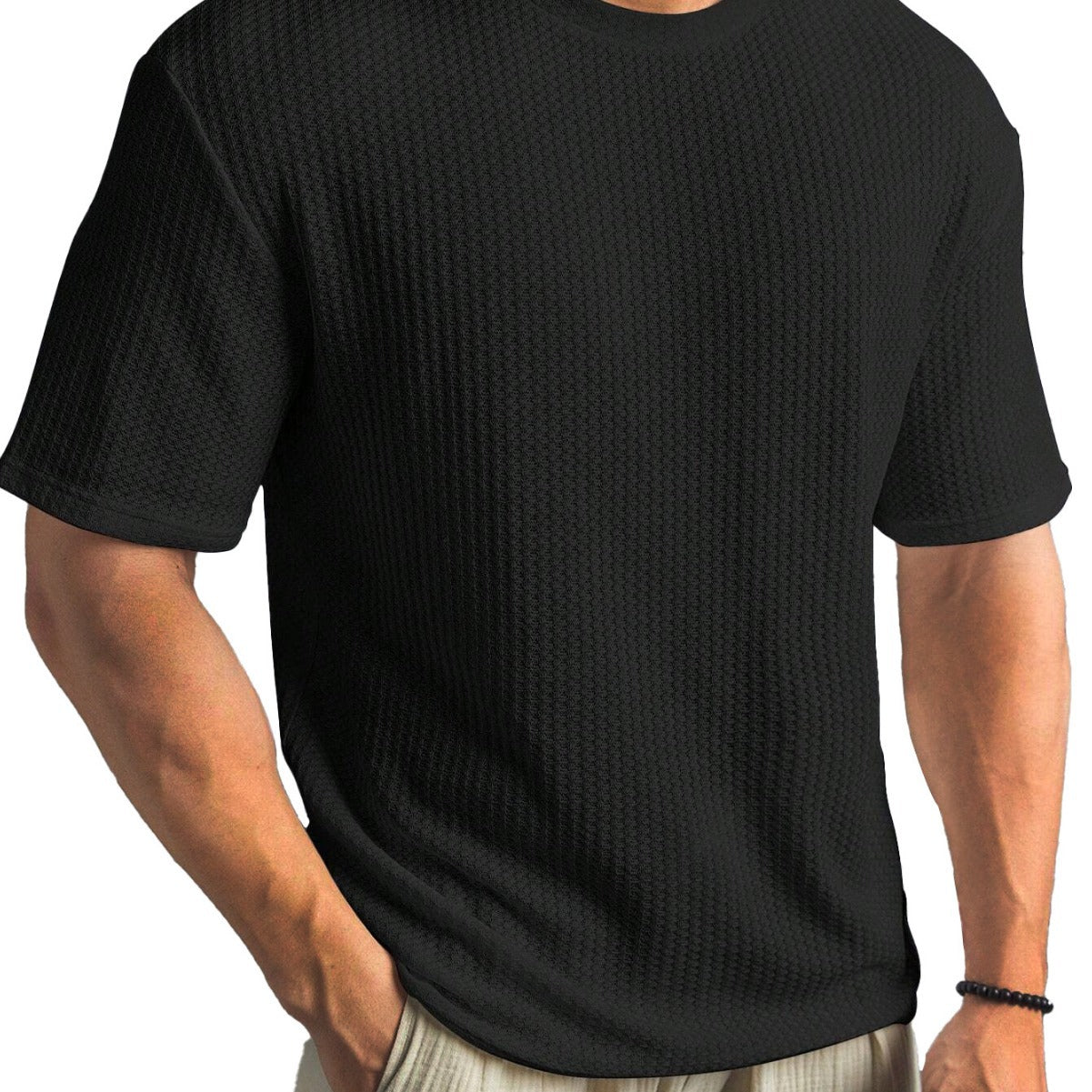 Black textured t-shirt worn by a person on a white background