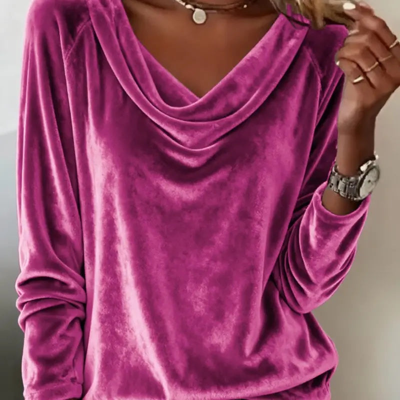 Purple velvet long-sleeve top worn by a person