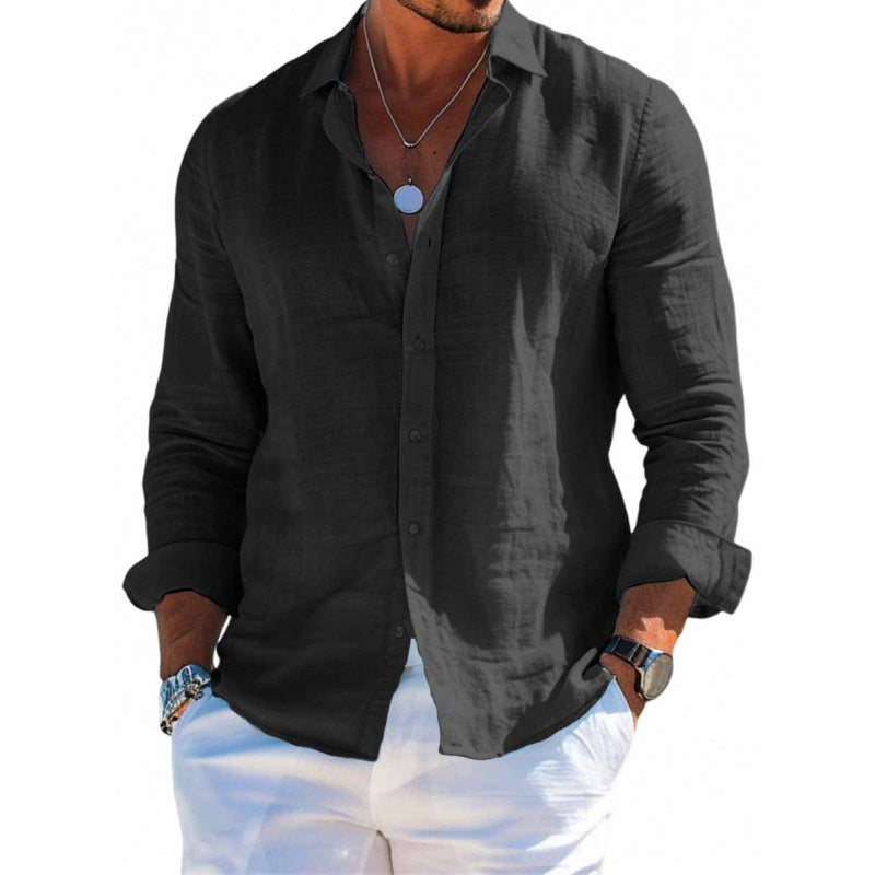Man wearing a black button-up shirt with rolled-up sleeves on a white background