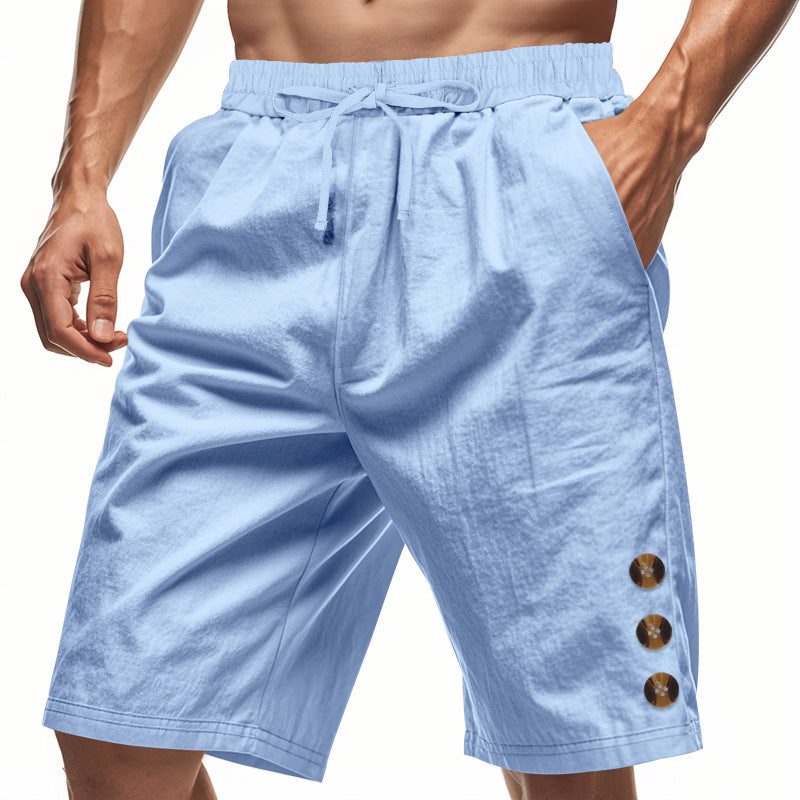 Light blue shorts with button details on a white background