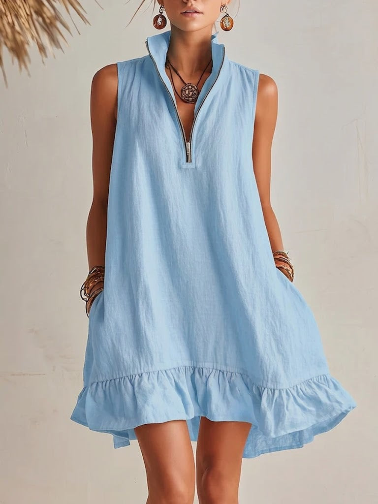 Woman wearing a light blue dress with a neutral background
