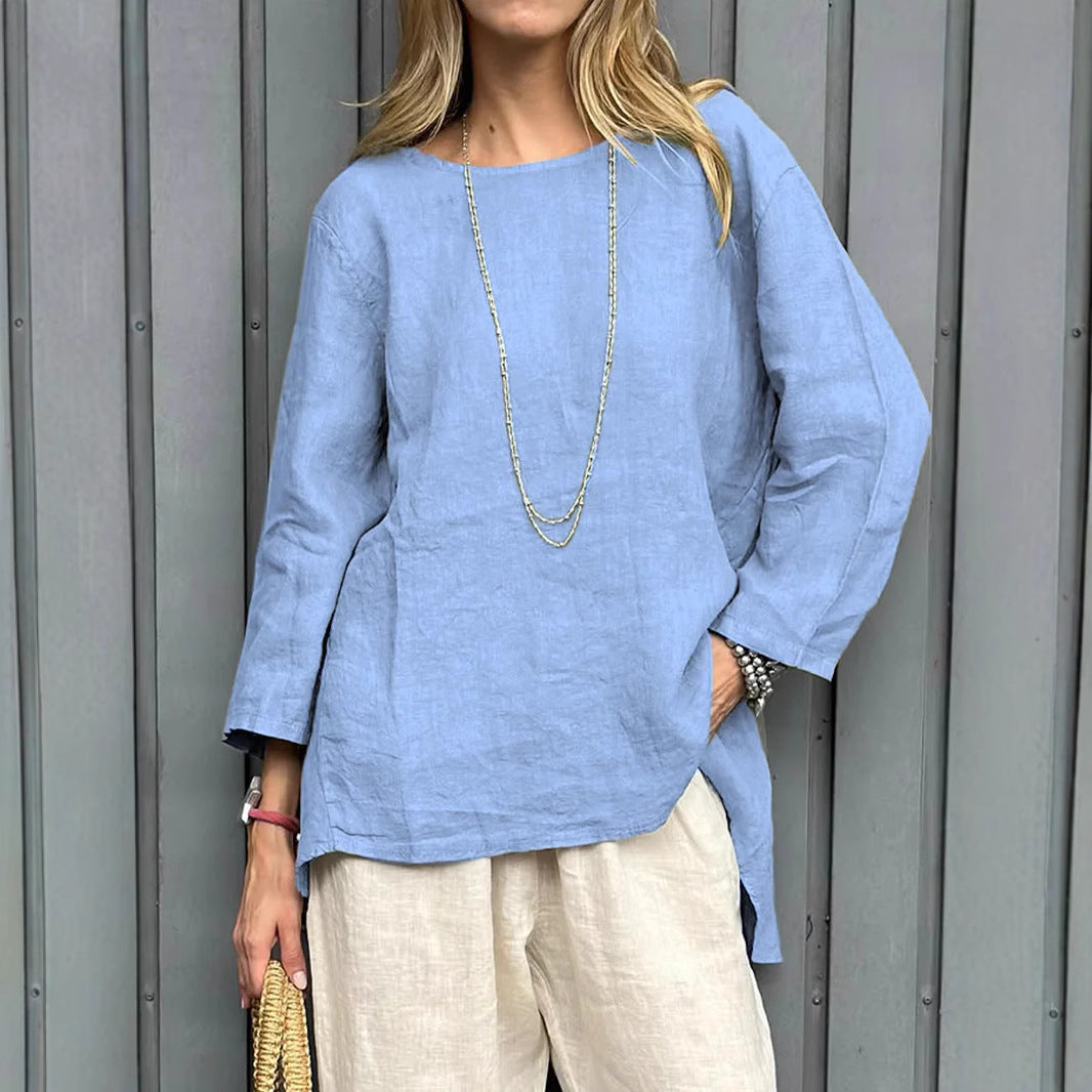 Woman wearing a light blue linen top and beige pants against a gray background