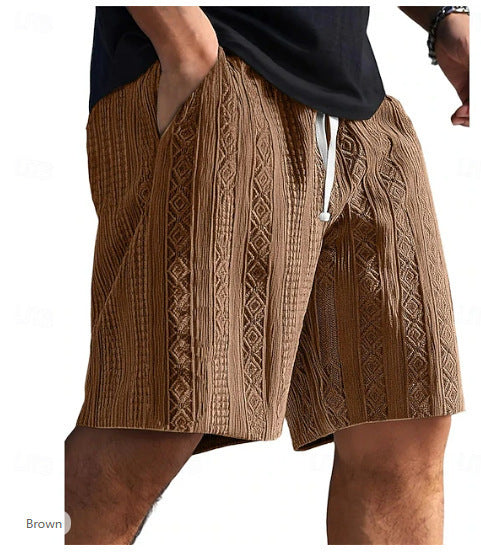 Brown patterned shorts worn by a person on a white background