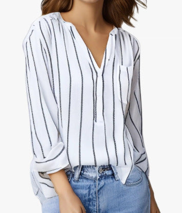 White blouse with black stripes worn by a person on a white background