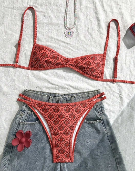 Red lace bikini set on a white background with denim shorts.