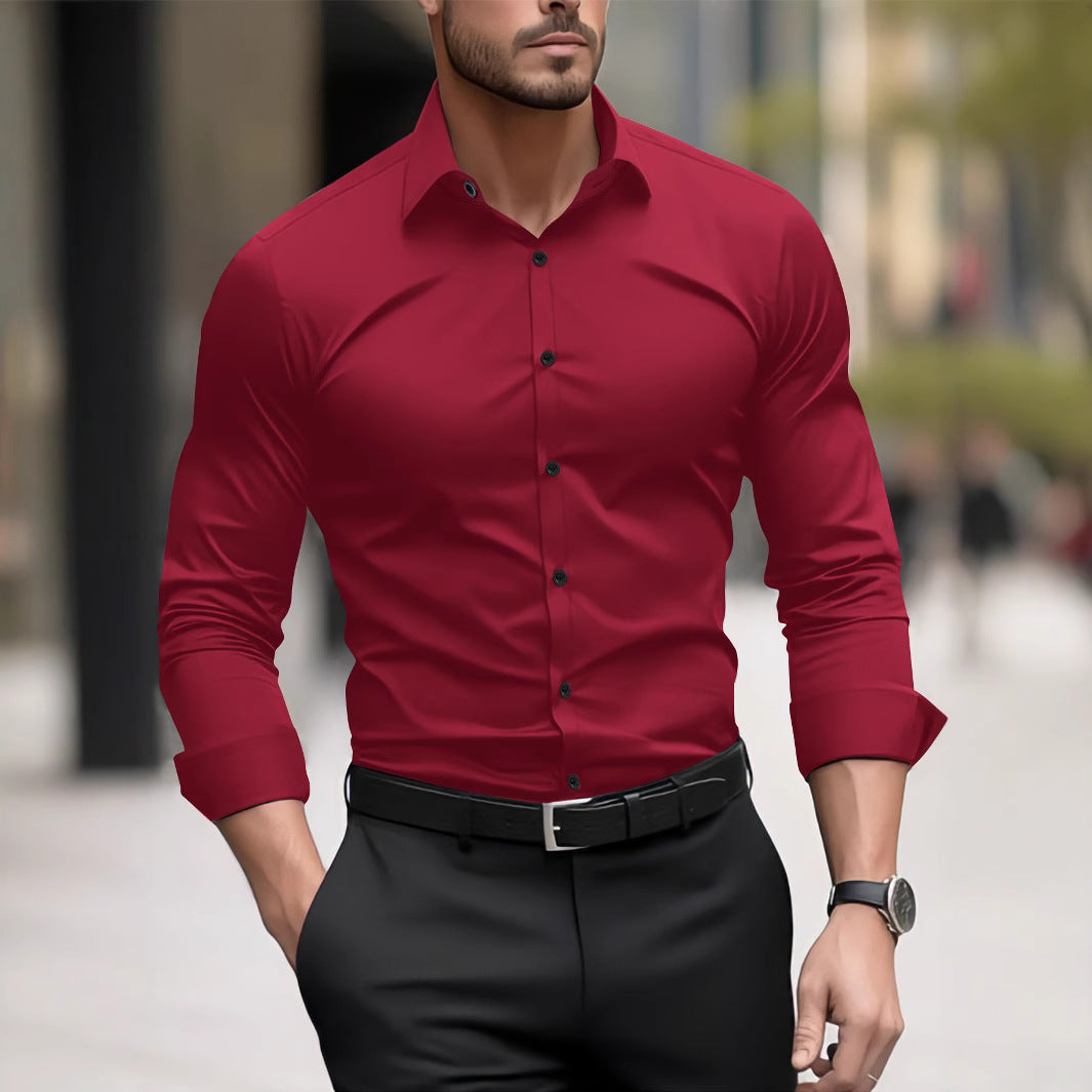 Man wearing a red dress shirt with black buttons and black pants on a blurred street background