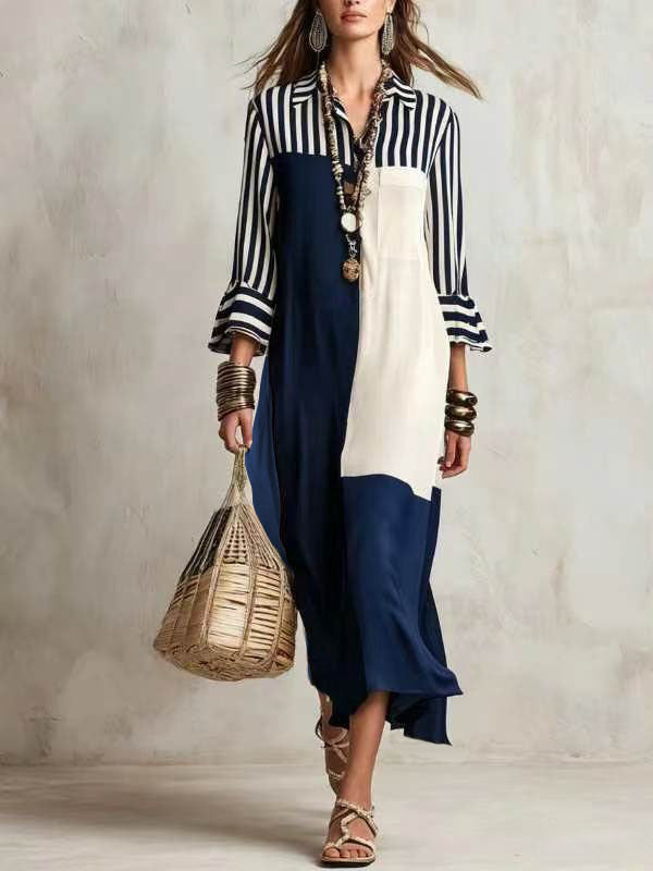 Woman wearing a black and white striped shirt with a navy and white dress, holding a woven bag against a neutral background.