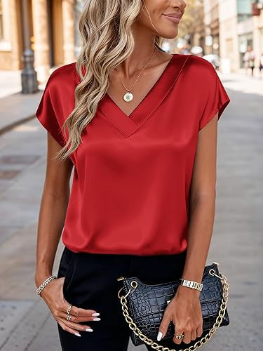 Woman wearing a red blouse with a blurred street background