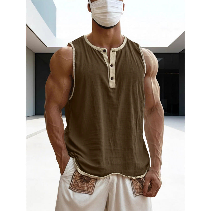 Person wearing a brown tank top with white trim and white pants in an indoor setting