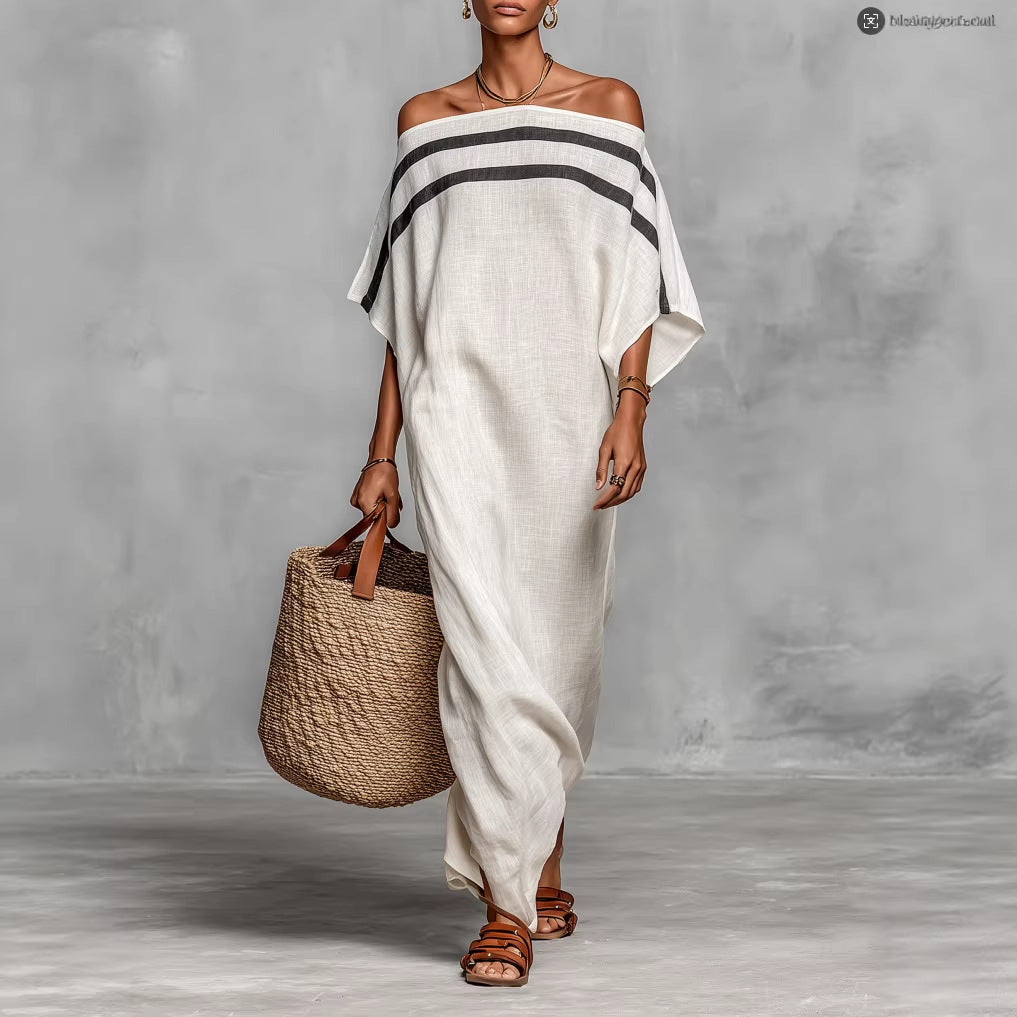 Woman wearing a white off-shoulder dress with black stripes, holding a woven bag against a gray background.