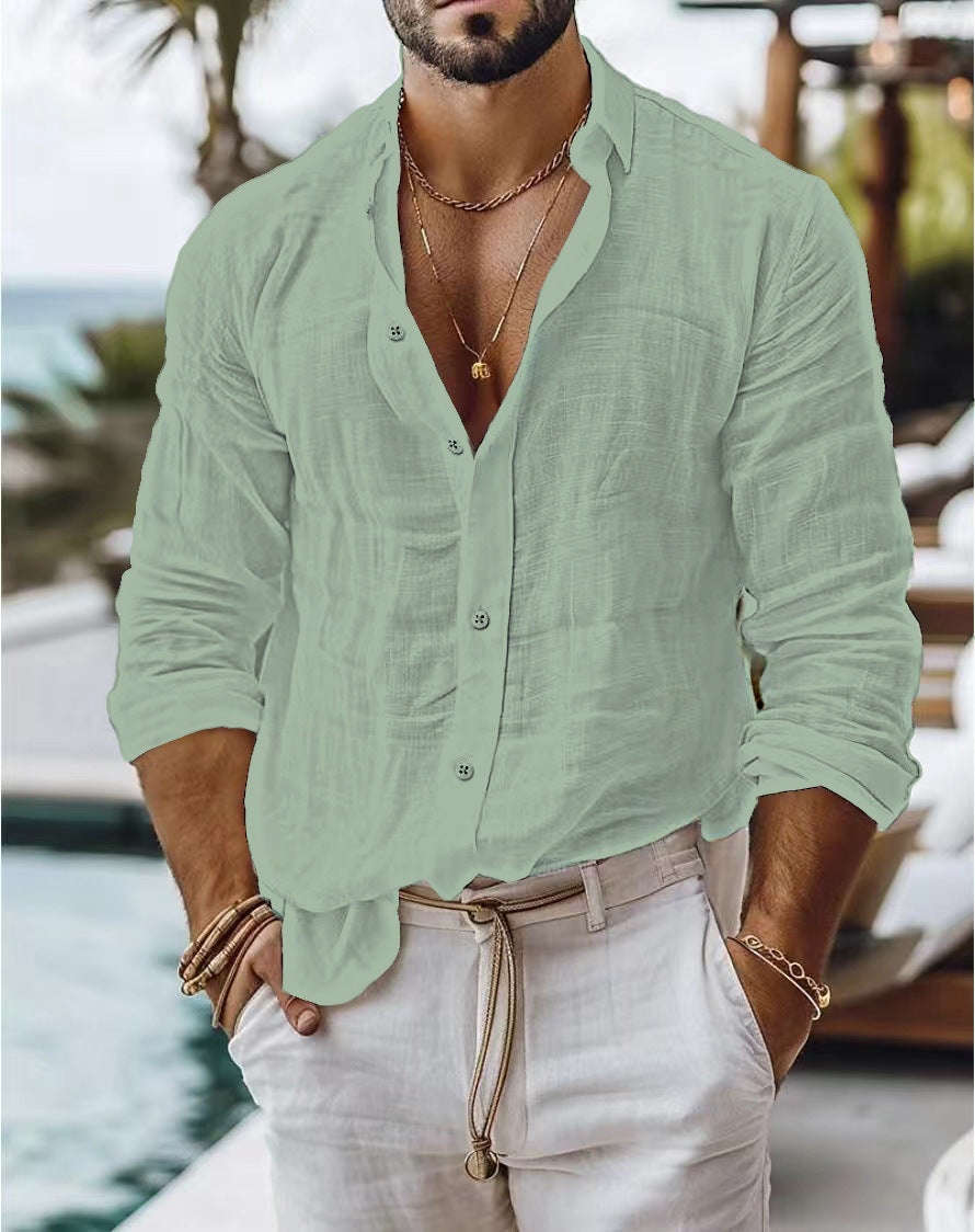 Man wearing a light green button-up shirt and beige pants by a poolside.