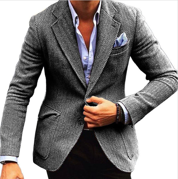 Gray herringbone blazer worn by a person on a white background