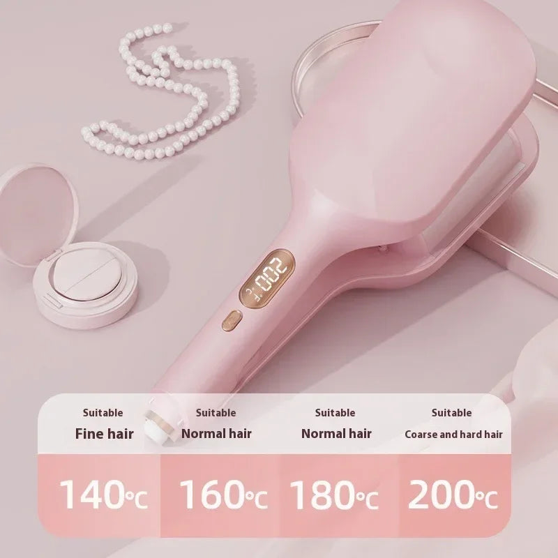 Pink hair straightener brush with digital display, pearl necklace, and compact on soft pink background, temperature settings for fine to coarse hair.