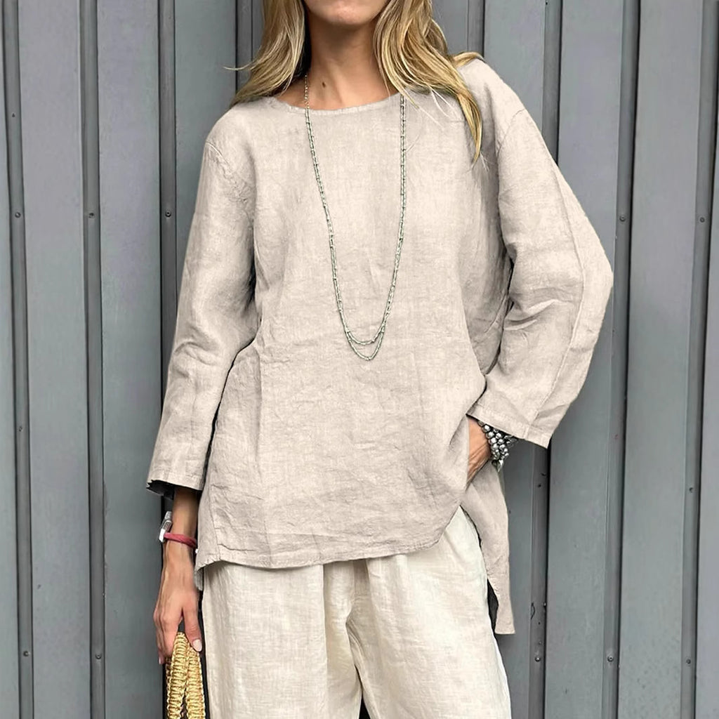 Woman wearing a beige linen outfit against a gray background