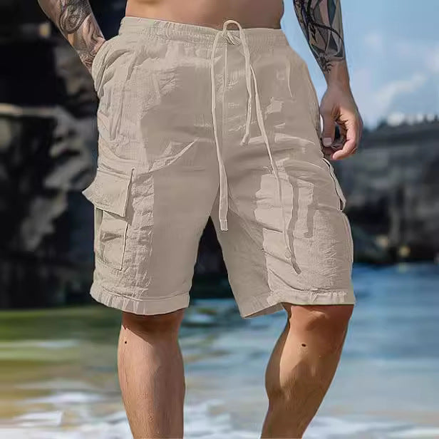 Person wearing beige cargo shorts by a body of water