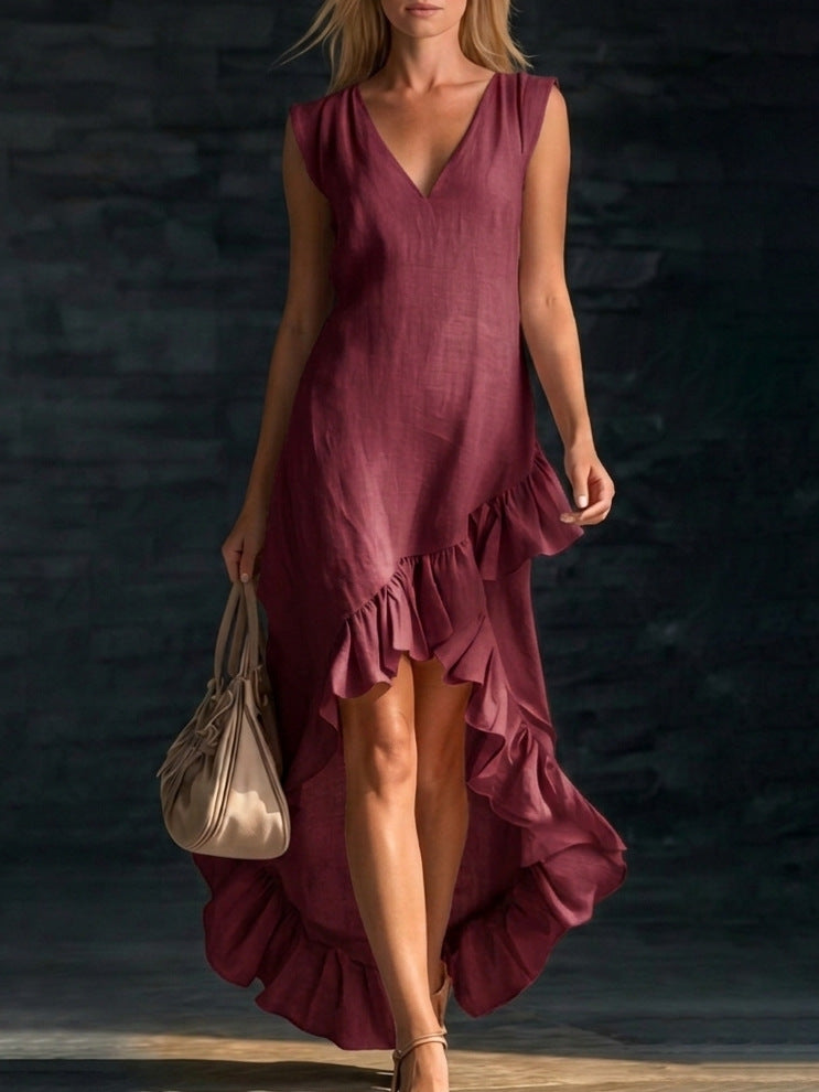 Woman wearing a burgundy dress with ruffles against a dark background