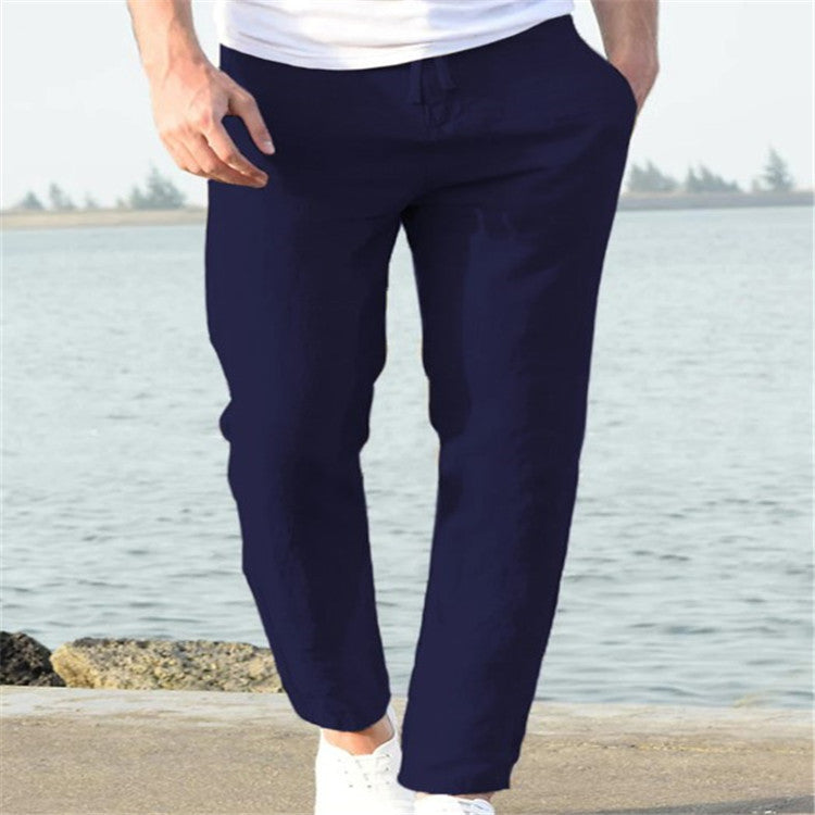 Navy blue pants worn by a person standing by a body of water.