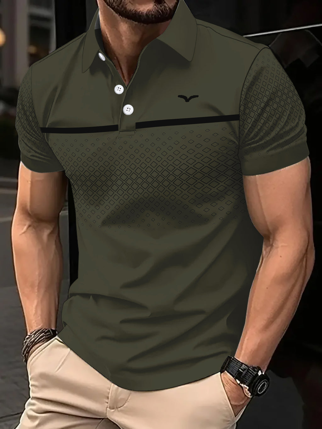 Man wearing a green polo shirt with a black stripe and logo, standing against a blurred background.