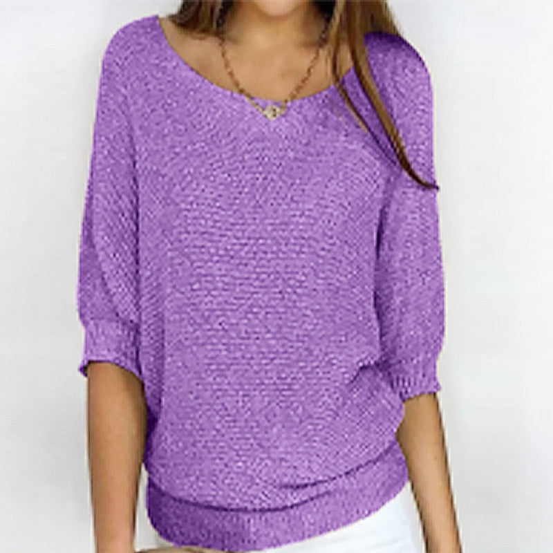 Person wearing a purple sweater against a white background
