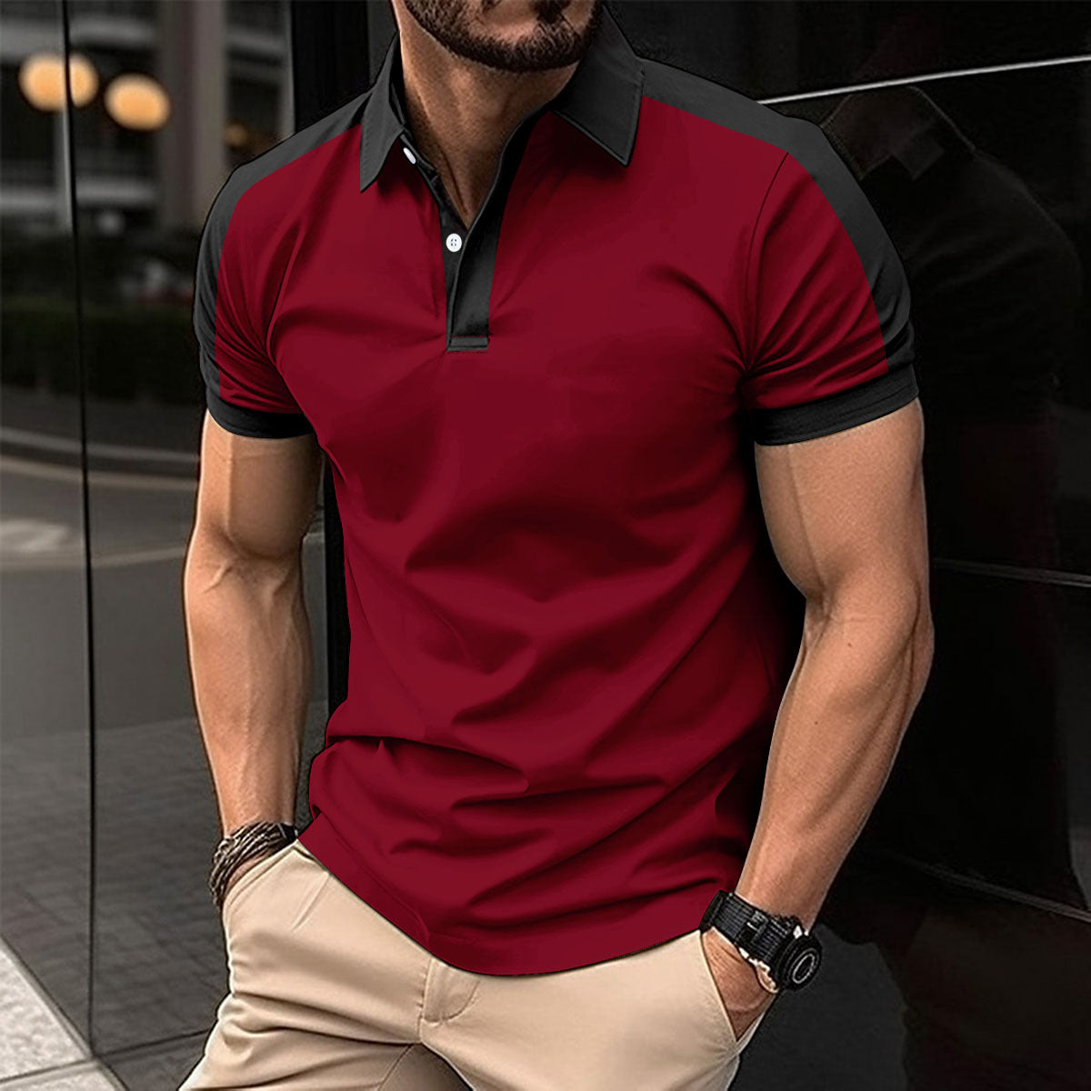 Man wearing a red and black polo shirt with beige pants in an urban setting.