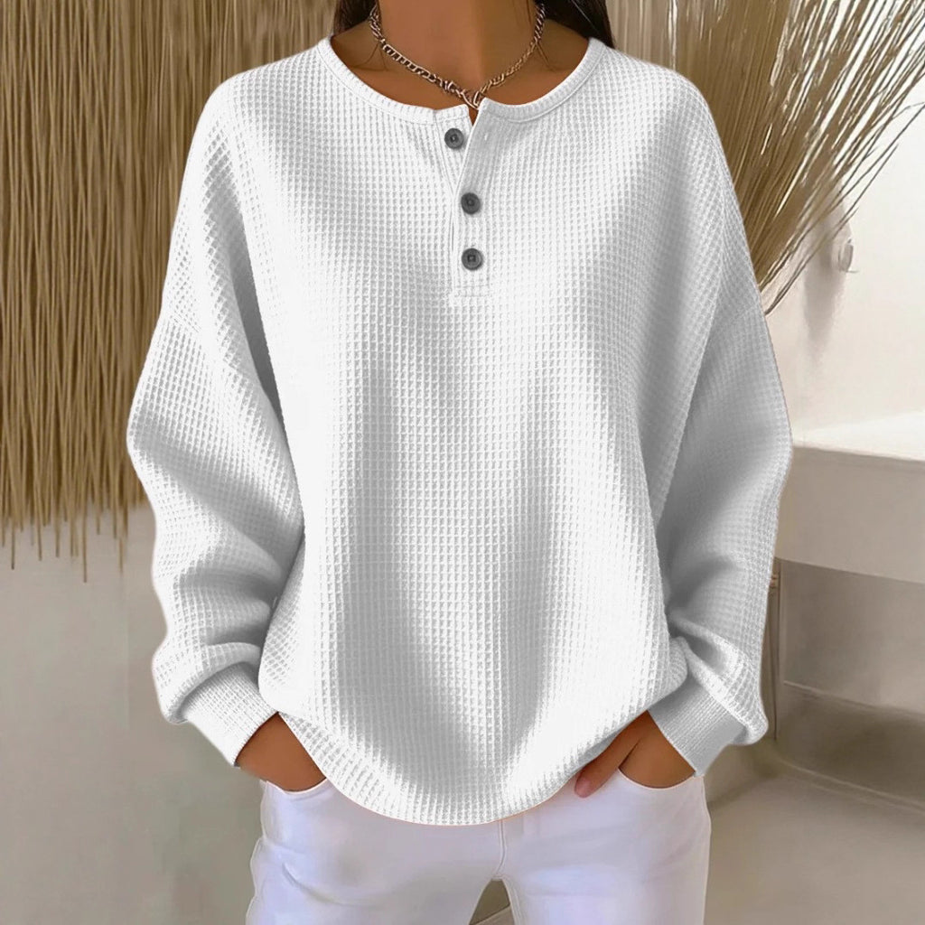 White textured long-sleeve shirt with buttons worn by a person against a neutral background