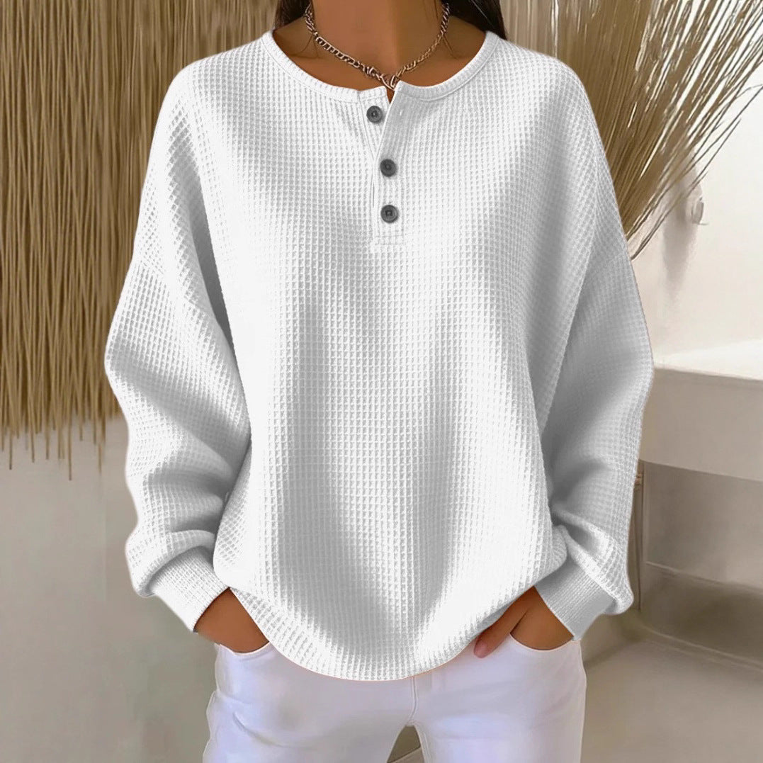 White textured long-sleeve shirt with buttons worn by a person against a neutral background