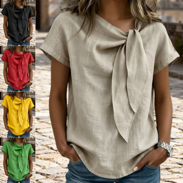 Woman wearing a beige top with a bow detail in various color options.