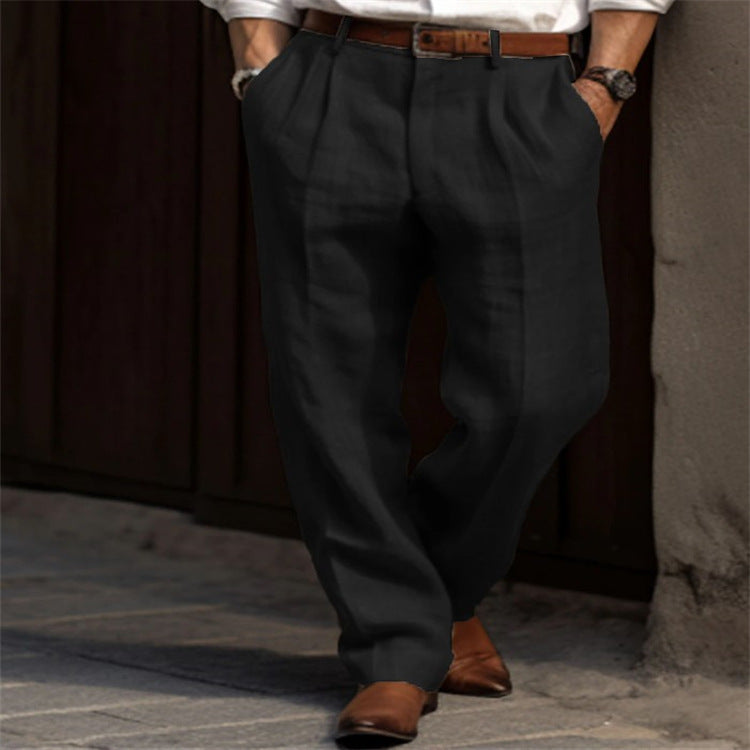 Person wearing dark gray pants and brown shoes against a neutral background
